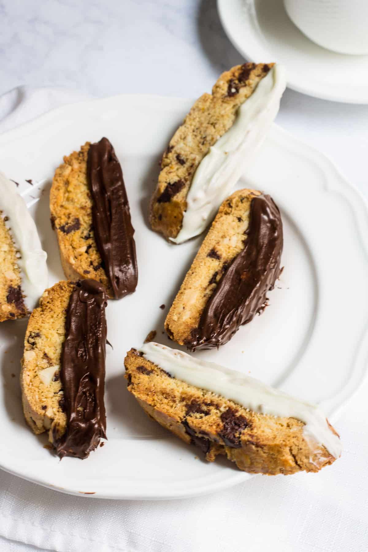 Chocolate-Dipped Almond Biscotti: a crisp almond cookie filled with dark chocolate, orange zest, and almonds. Perfect as a winter dessert, served with a cup of hot coffee. Recipe via MonPetitFour.com