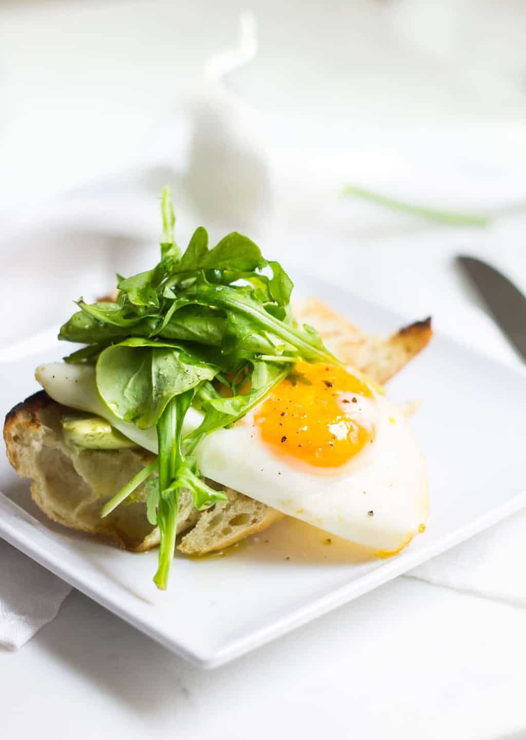 Egg Toast with avocado, arugula, lemon, and olive oil. A perfect breast or lunch! Recipe via MonPetitFour.com