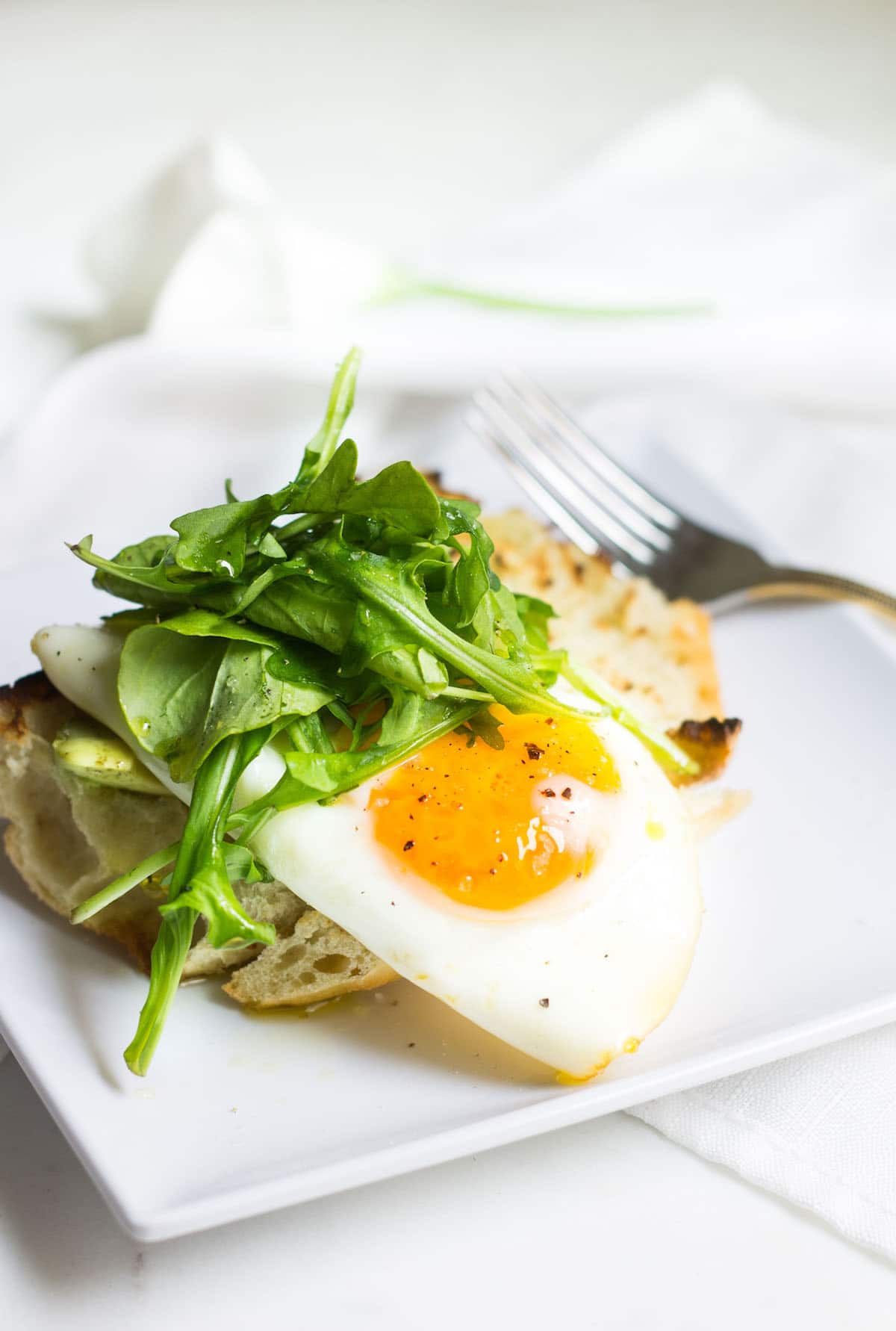 Egg Toast with avocado, arugula, lemon, and olive oil. A perfect breast or lunch! Recipe via MonPetitFour.com