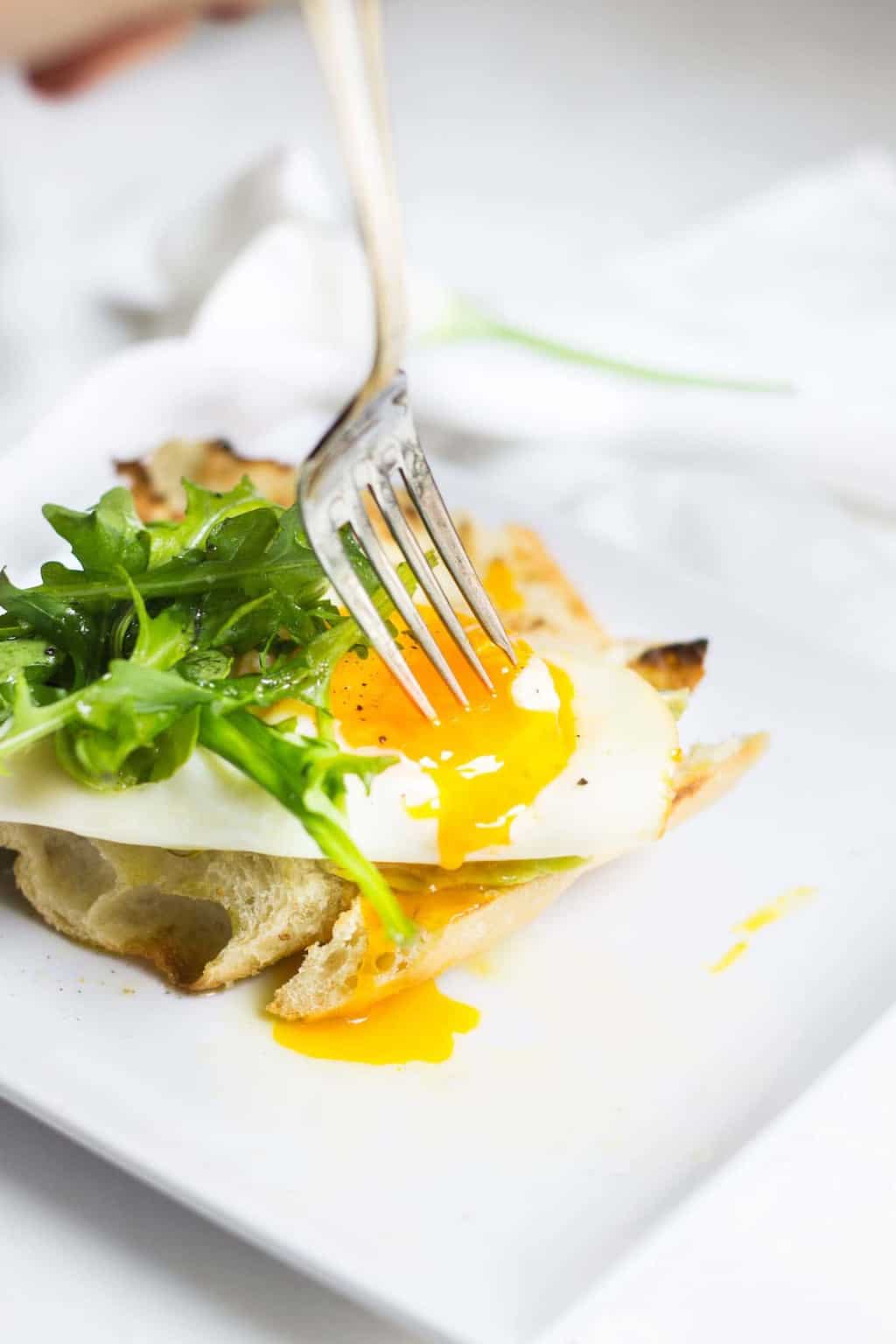 Egg Toast with avocado, arugula, lemon, and olive oil. A perfect breast or lunch! Recipe via MonPetitFour.com