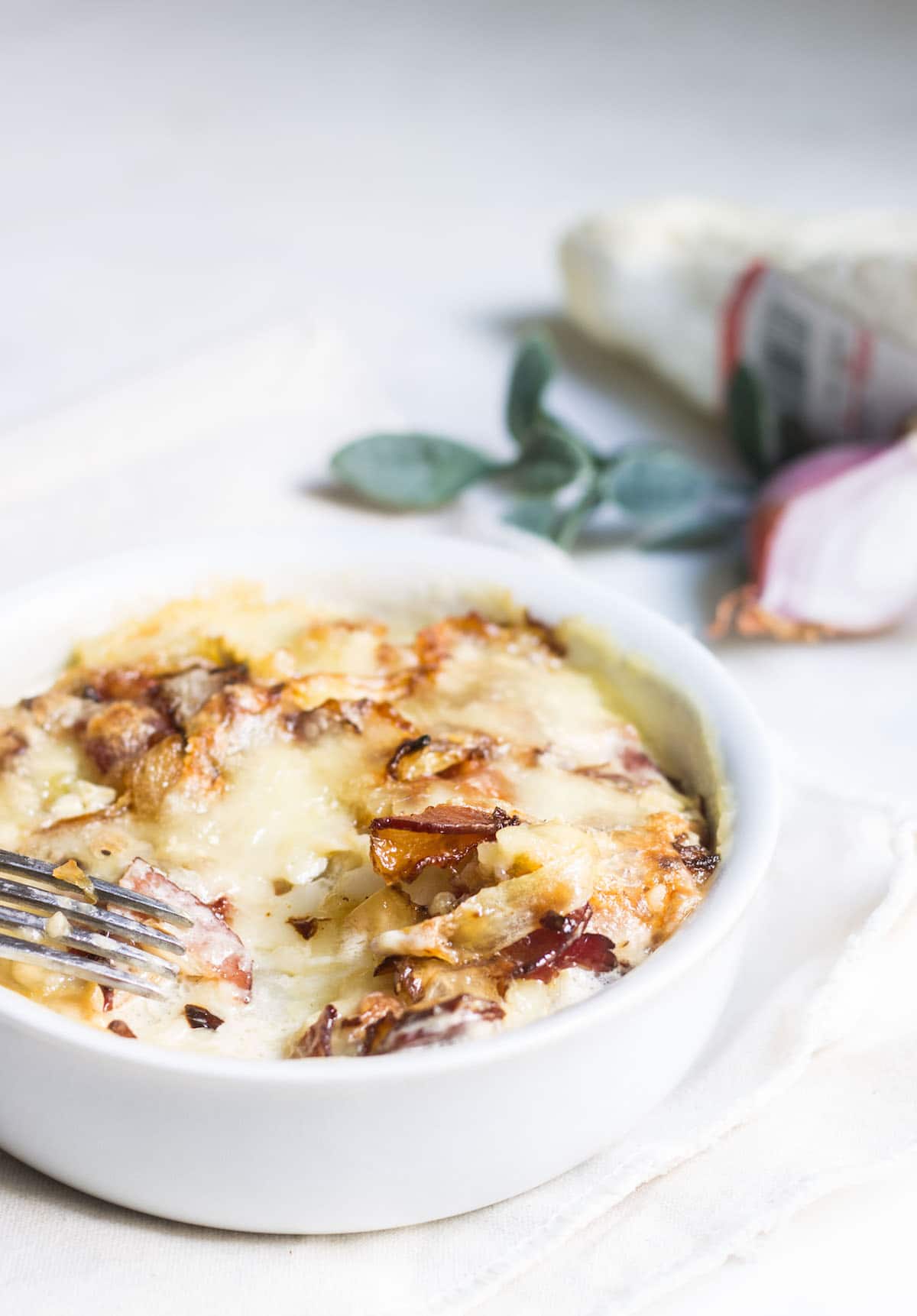 Tartiflette: the ultimate cheesy potato bake with bacons and creamy brie! Recipe via MonPetitFour.com
