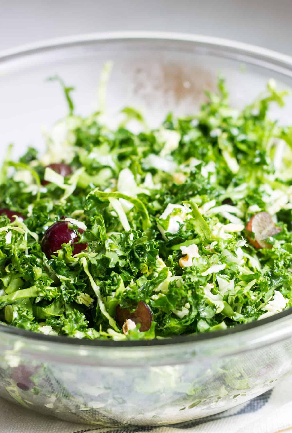 Kale Brussels Sprout Salad: A delicious & healthy, go-to salad to enjoy on its own or with your favorite entrée! Recipe via MonPetitFour.com