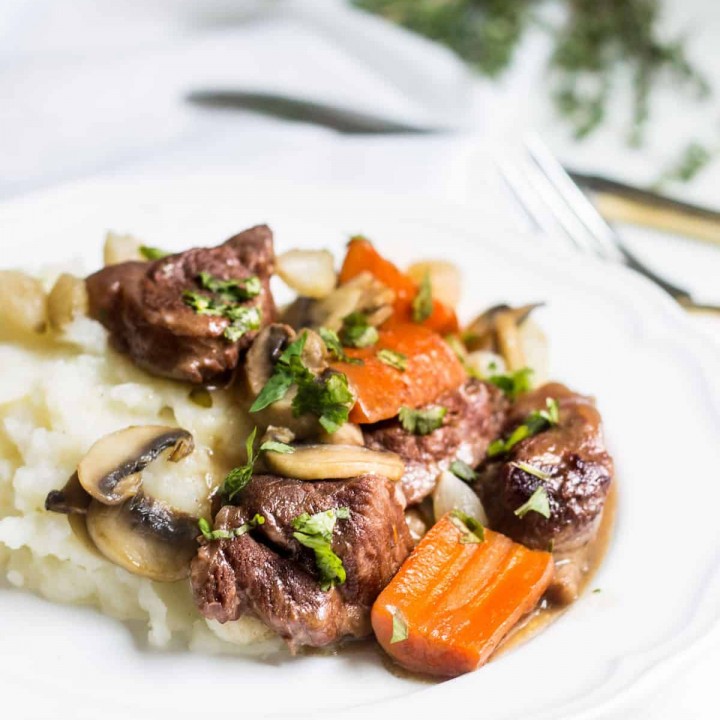 Beef Bourguignon: slow-cooked beef stew served with carrots, mushrooms, and mashed potatoes. Recipe via MonPetitFour.com