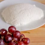 homemade ricotta cheese next to grapes