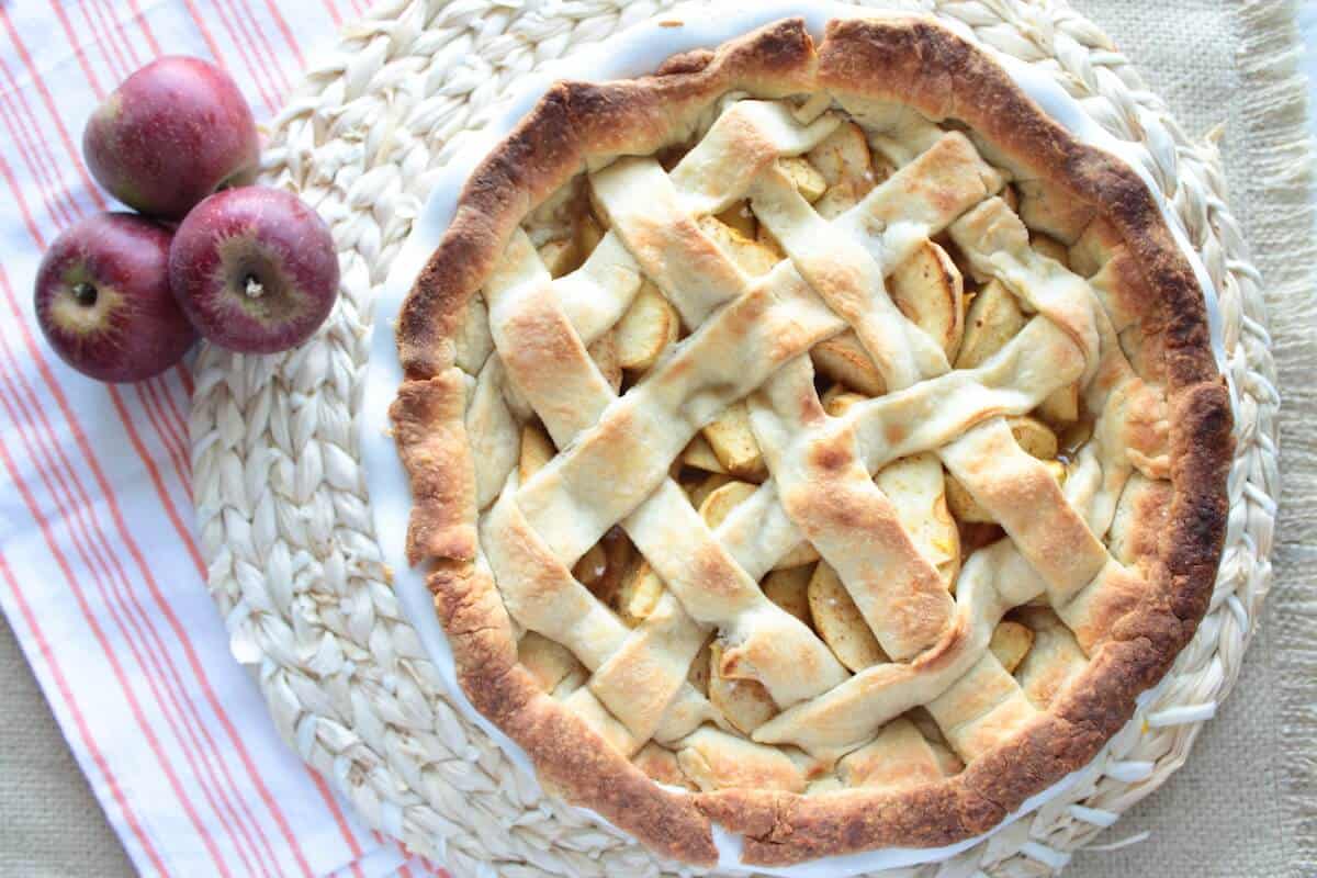 easy apple pie recipe in a pie dish next to apples