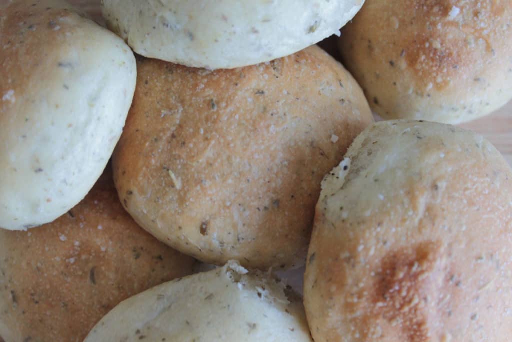 herbed dinner rolls recipe piled on top of each other image