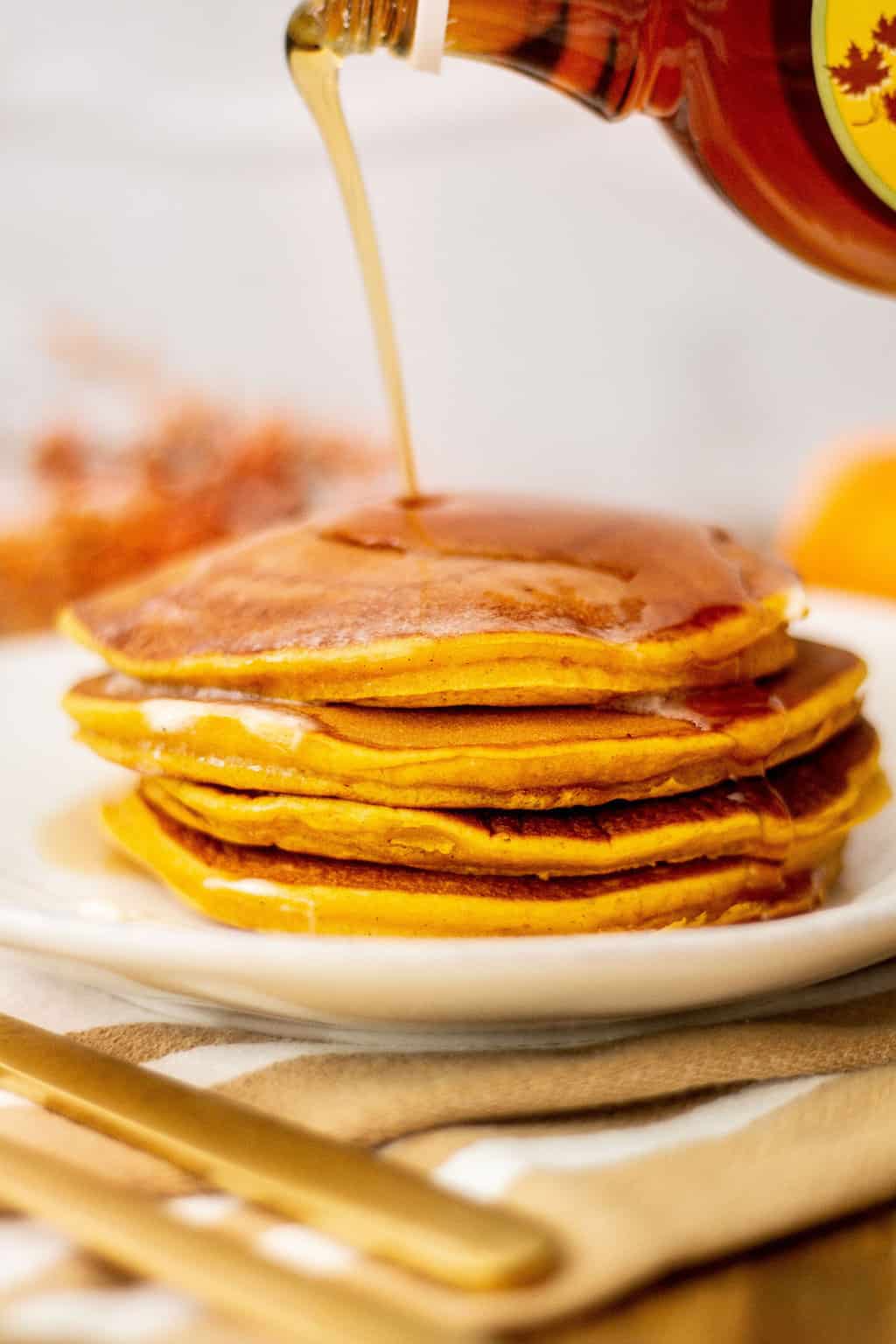pumpkin spice pancakes syrup poured on top