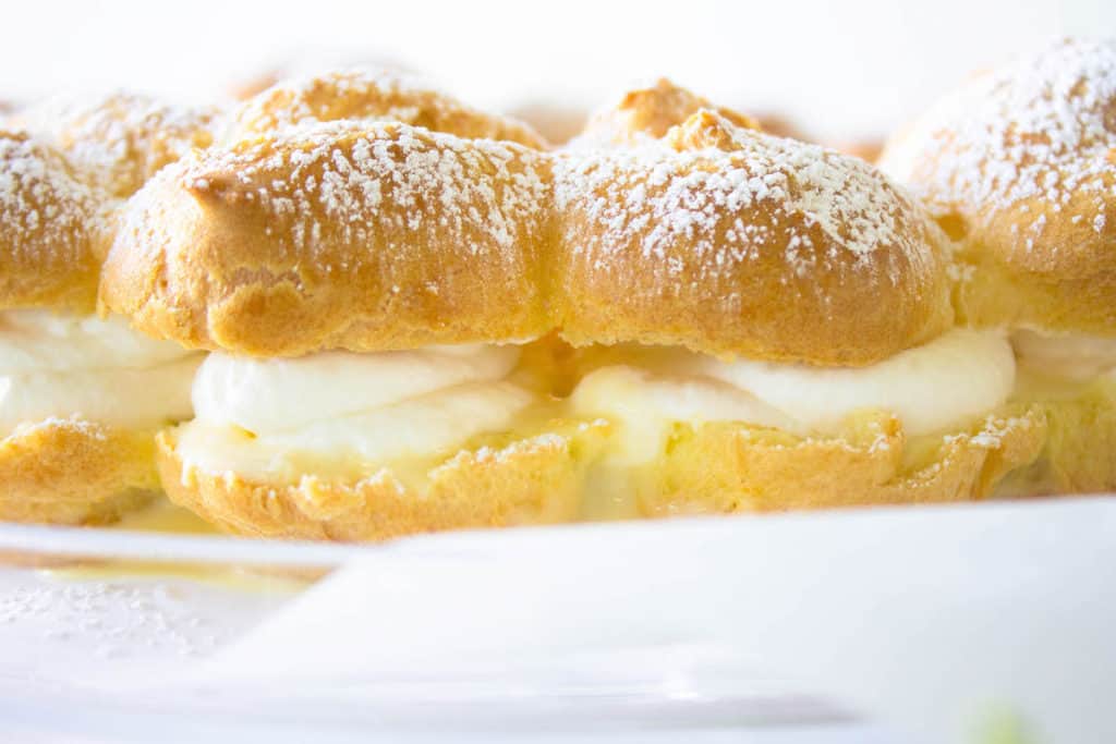 cream puffs filled with whipped cream and custard image