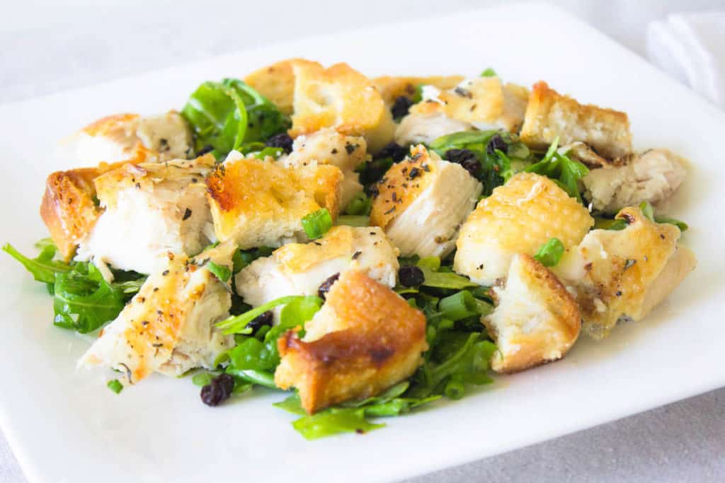roast chicken on arugula with bread croutons image