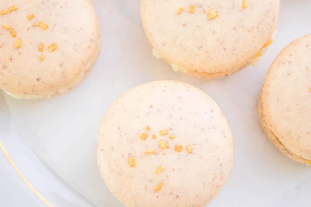 Gold sprinkles on top of French macarons