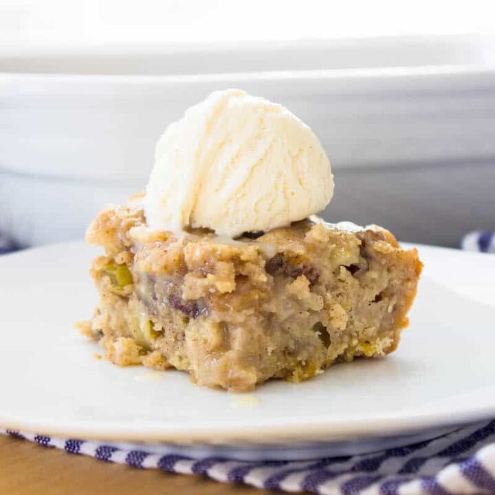 apple spice cake slice with vanilla ice cream on top close-up view