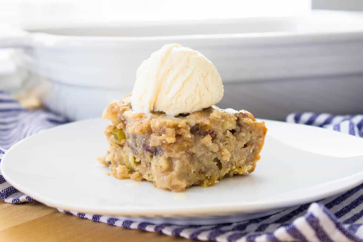 apple spice cake slice with vanilla ice cream on top close-up view