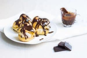 Profiteroles Recipe on a plate with warm chocolate sauce