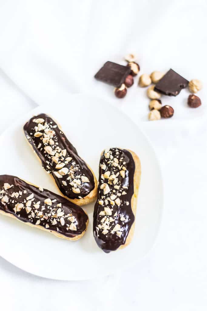 chocolate eclairs on a plate image