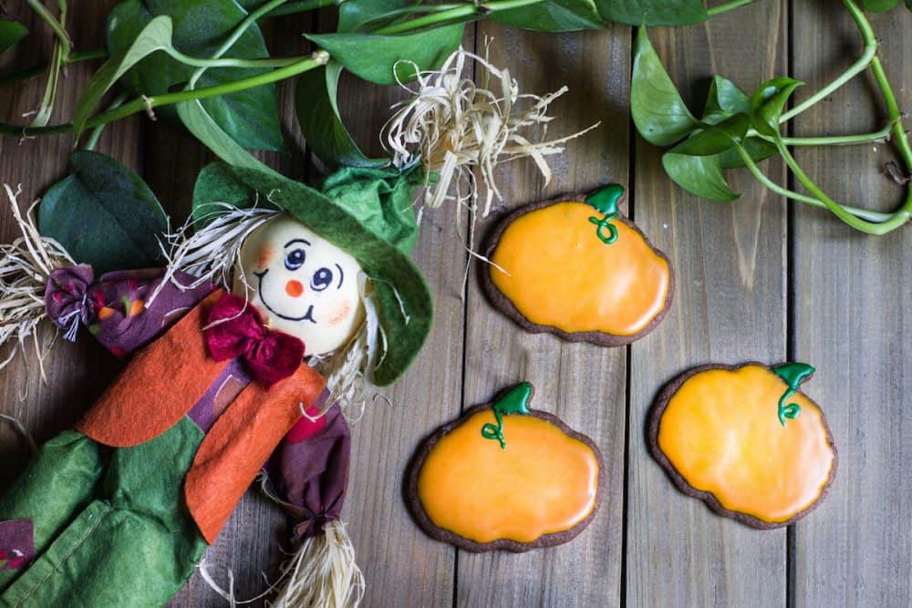 Halloween Cookies decorated into pumpkins with orange icing