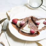 Chocolate Crepes filled with cream and fresh raspberries, then dusted with powdered sugar. So easy and so delicious! Recipe via MonPetitFour.com