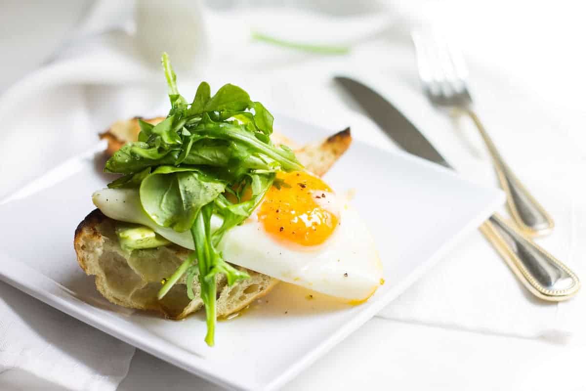 Egg Toast with avocado, arugula, lemon, and olive oil. A perfect breast or lunch! Recipe via MonPetitFour.com
