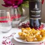 Fig Brie Bites perfect for entertaining! Creamy brie inside golden puff pastry, topped with sweet fig preserves and crunchy walnut pieces. Recipe via MonPetitFour.com