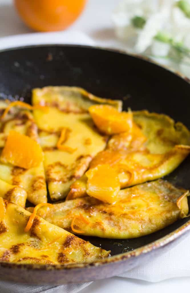 Crepes Suzette with orange sauce in a skillet