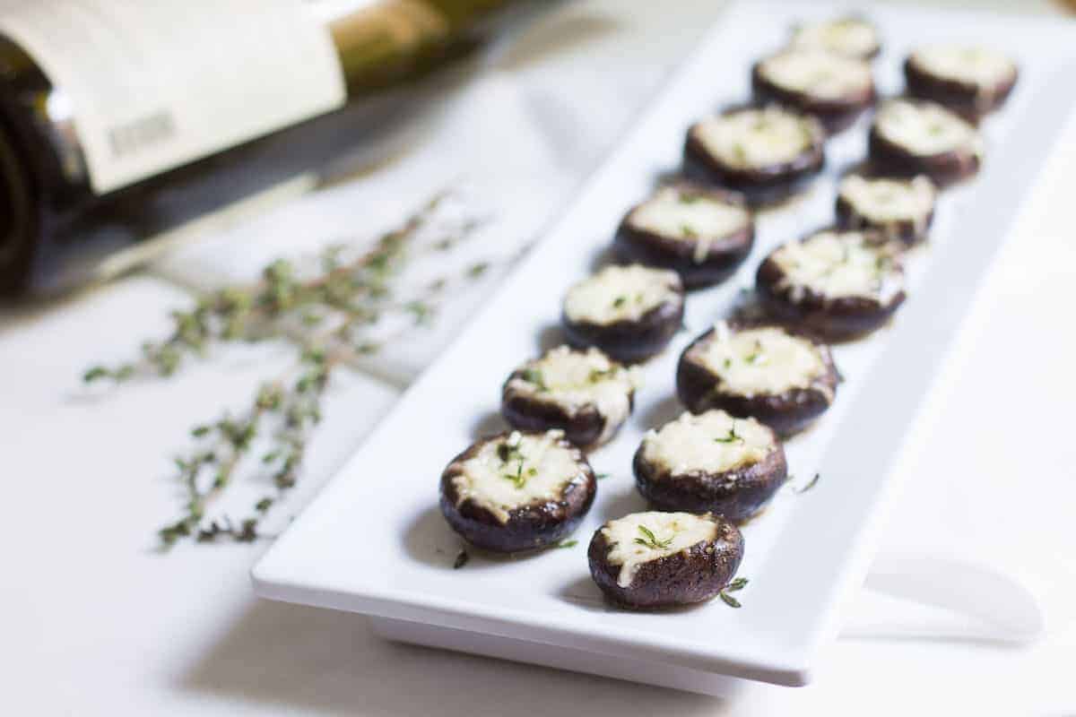 Garlic Stuffed Mushrooms: crimini mushrooms stuffed with garlic butter and parmesan cheese. Perfect appetizer or side dish! French recipe via MonPetitFour.com