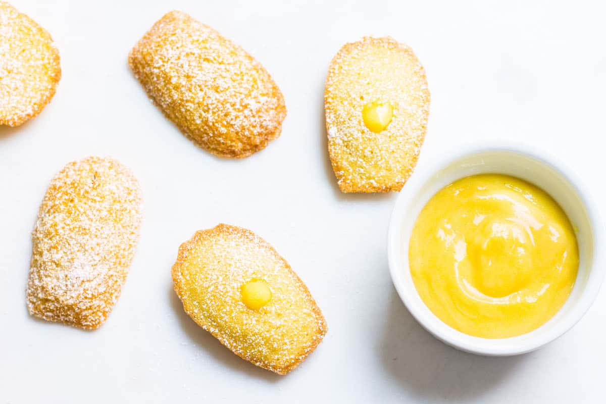 Madeleines with Lemon Curd: sweet little French cakes filled with delicious lemon curd. Recipe via MonPetitFour.com