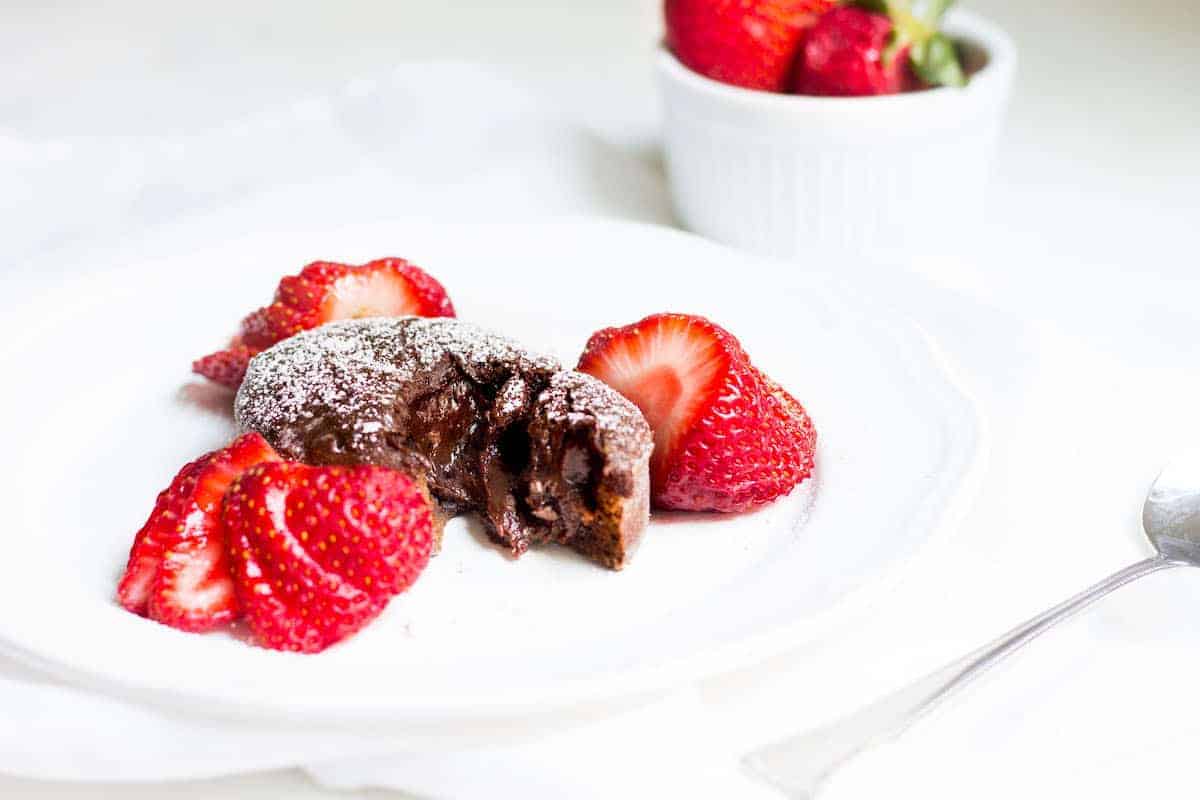 Molten Chocolate Cake: decadent little chocolate cakes with surprise gooey centers! Recipe via MonPetitFour.com