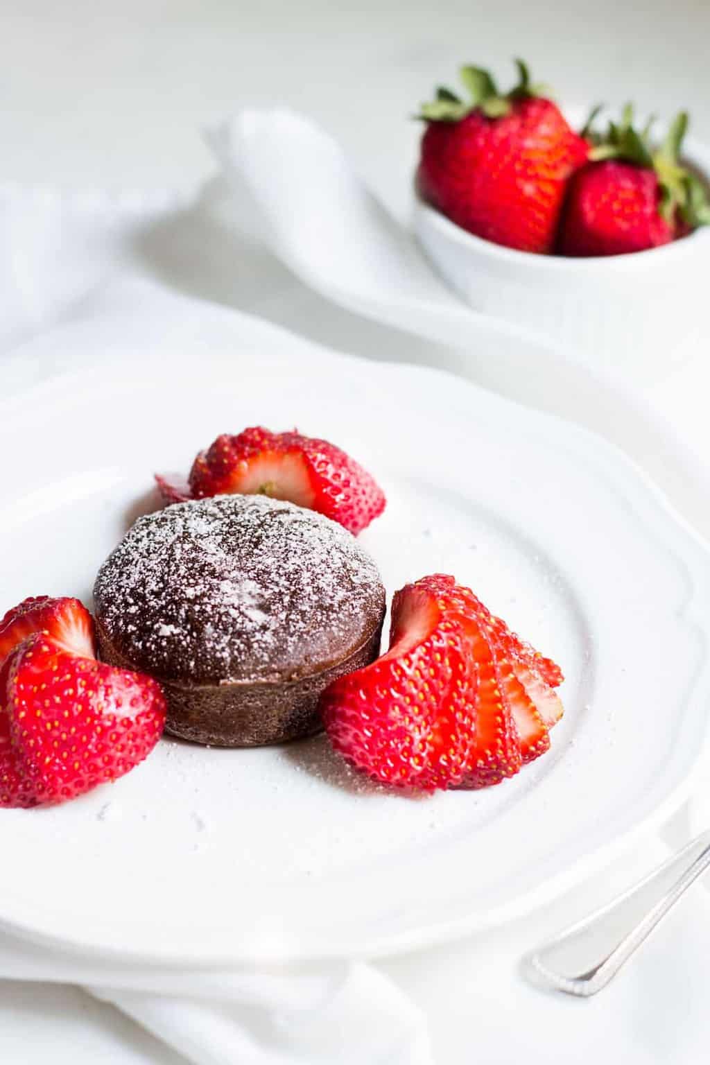 Molten Chocolate Cake: decadent little chocolate cakes with surprise gooey centers! Recipe via MonPetitFour.com