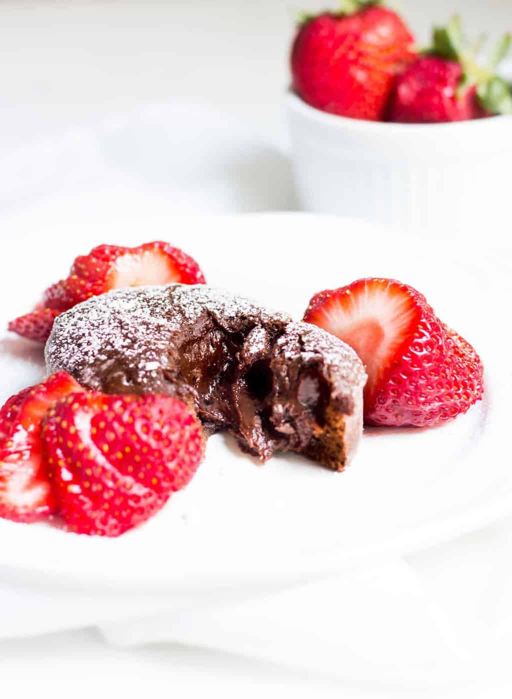 Molten Chocolate Cake: decadent little chocolate cakes with surprise gooey centers! Recipe via MonPetitFour.com