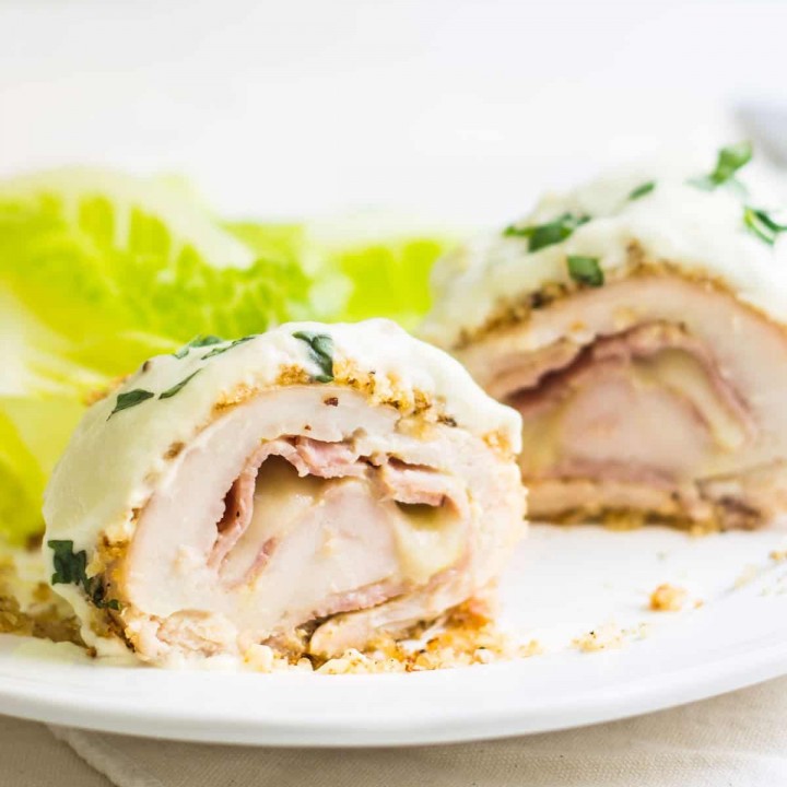 Chicken Cordon Bleu: an easy and quick French dinner! This classic is made with breaded chicken stuffed with ham and cheese. Topped with a dijon cream sauce. Recipe via MonPetitFour.com
