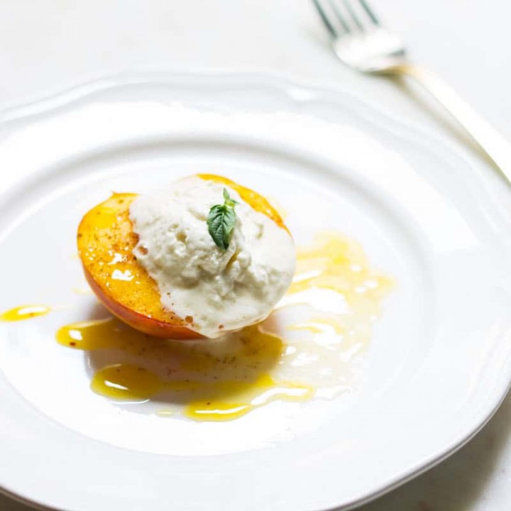 Baked Peaches with Cream: a quick and easy summer dessert made with ripe peaches and freshly whipped cream. A French recipe known as pêches rôties. Recipe via MonPetitFour.com