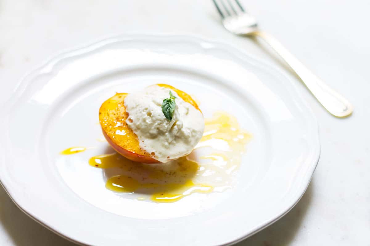 Baked Peaches with Cream: a quick and easy summer dessert made with ripe peaches and freshly whipped cream. A French recipe known as pêches rôties. Recipe via MonPetitFour.com