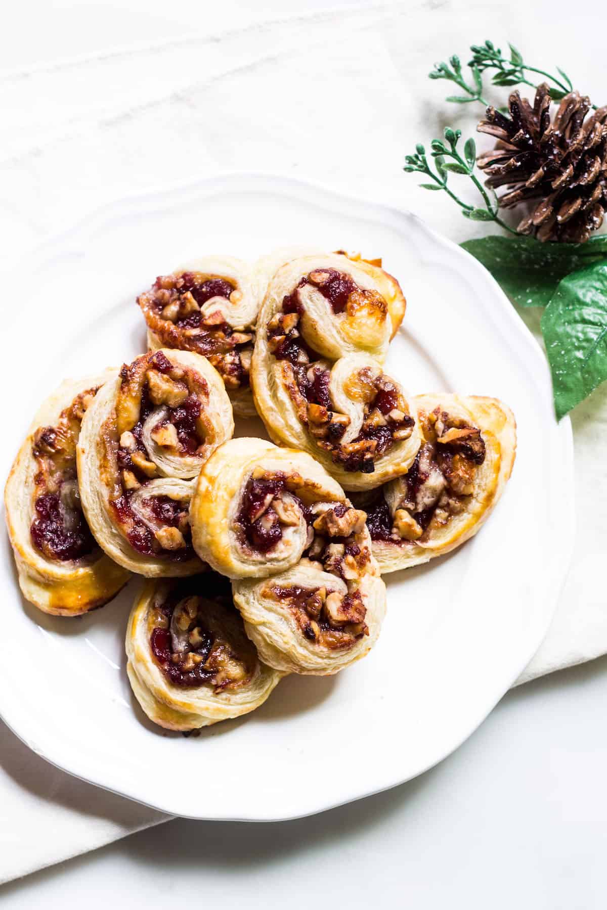 Savory Palmiers made with brie, walnuts, cranberry jelly, and Pepperidge Farm® Puff Pastry Sheets. A crowd-pleasing appetizer for any occasion or holiday! French recipe via MonPetitFour.com #ad #InspiredbyPuff