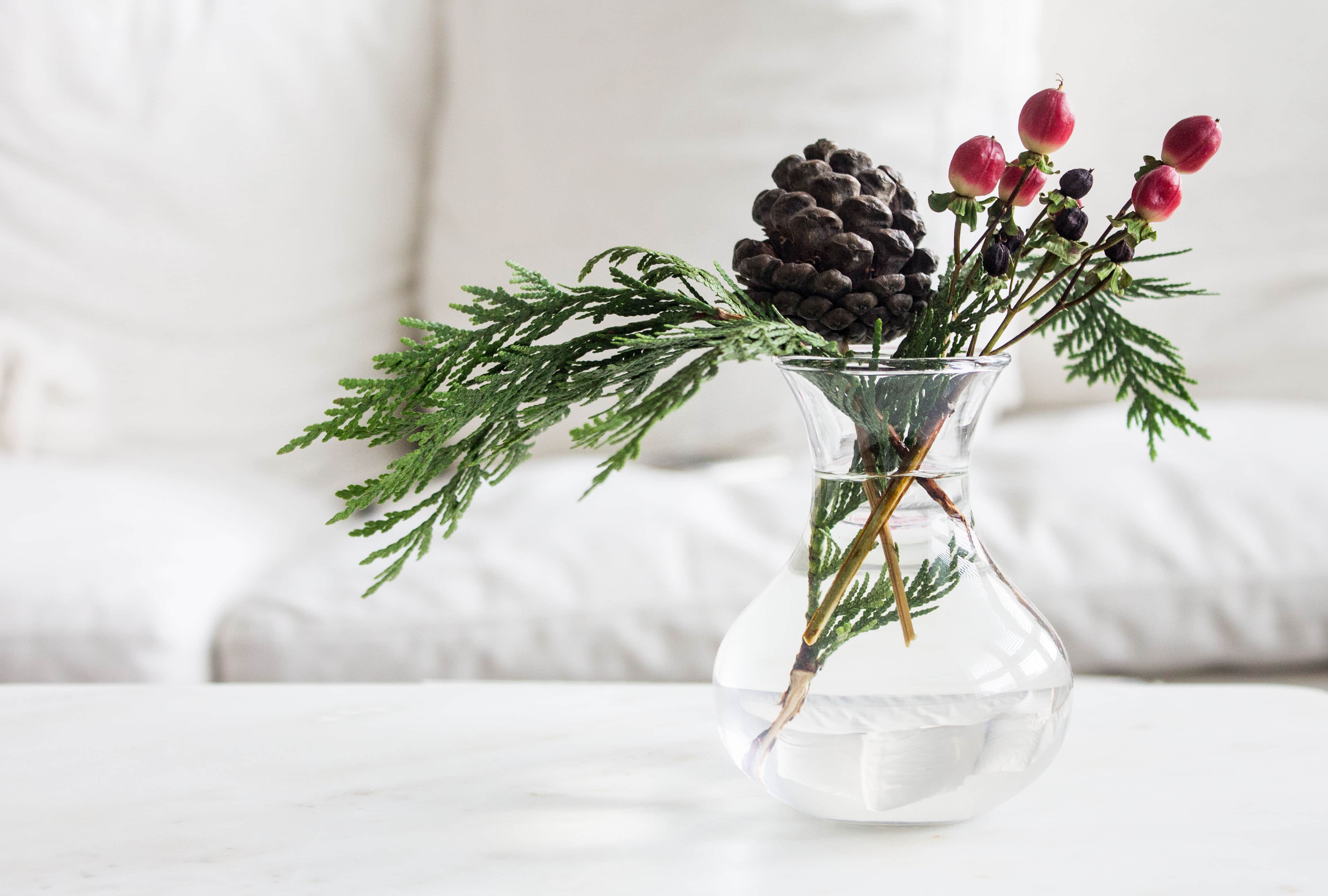 Small floral arrangements with evergreen and pine cone via MonPetitFour.com