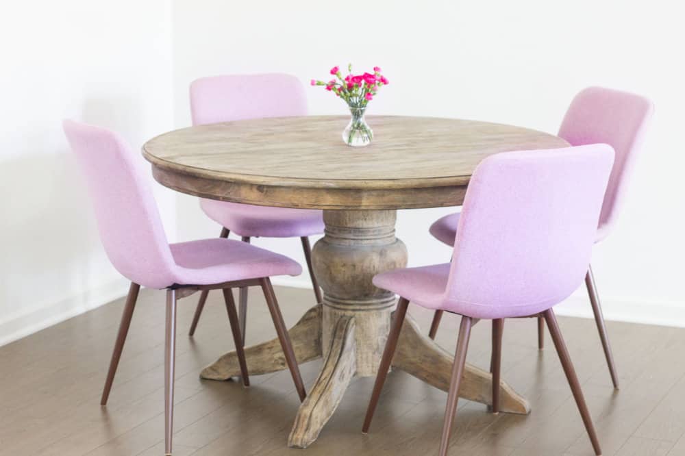 French dining table with pink Eames chairs hero image