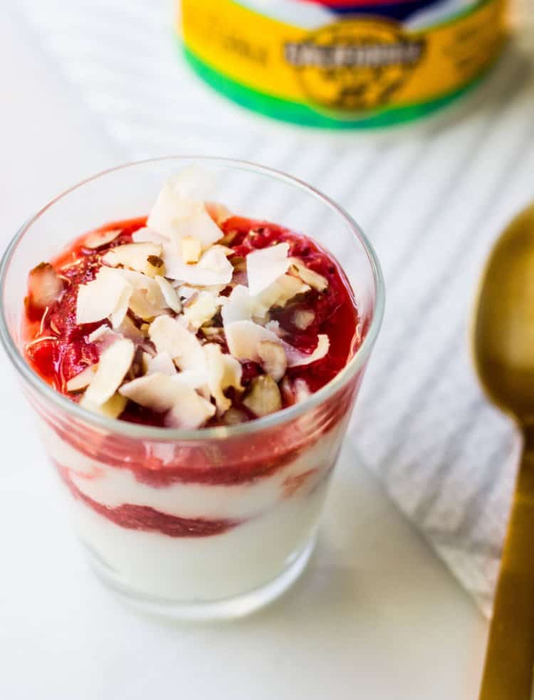 berry compote poured over real california milk yogurt in a glass