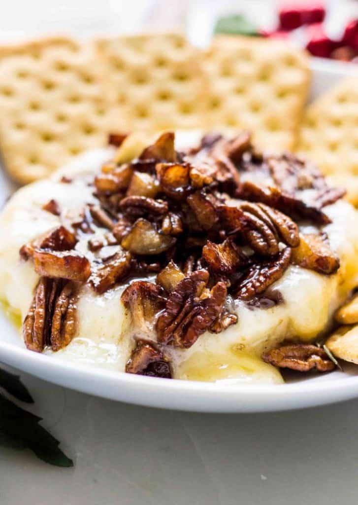 Baked brie with apple pecan topping close up shot