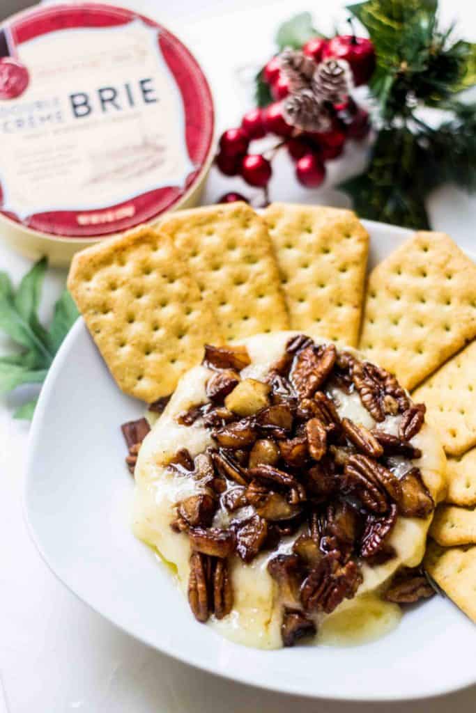 Baked Brie Recipe with apples and pecans served and served with crackers