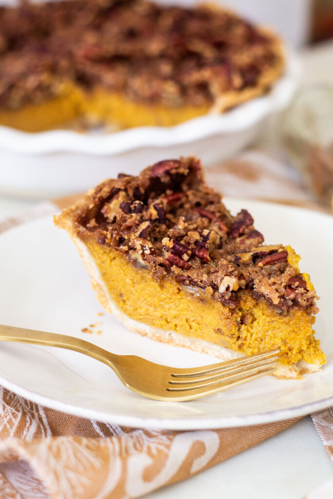 pumpkin pecan pie slice on a plate with a fork