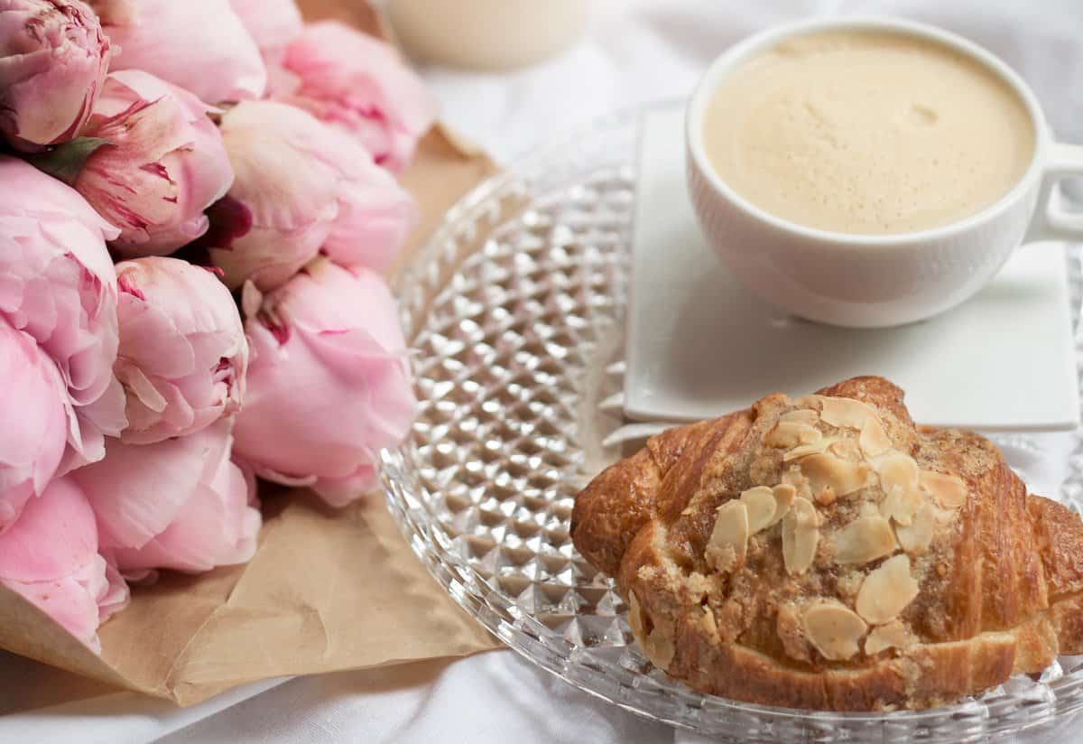 self-care routine image of croissant flowers and coffee