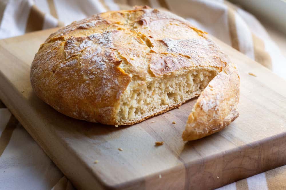 no-knead dutch oven bread on a wood board