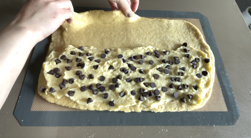 pain suisse dough being filled and folded