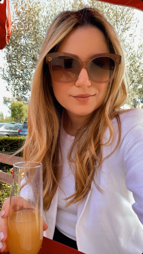 beeta wearing a white blazer with white top and black linen pants