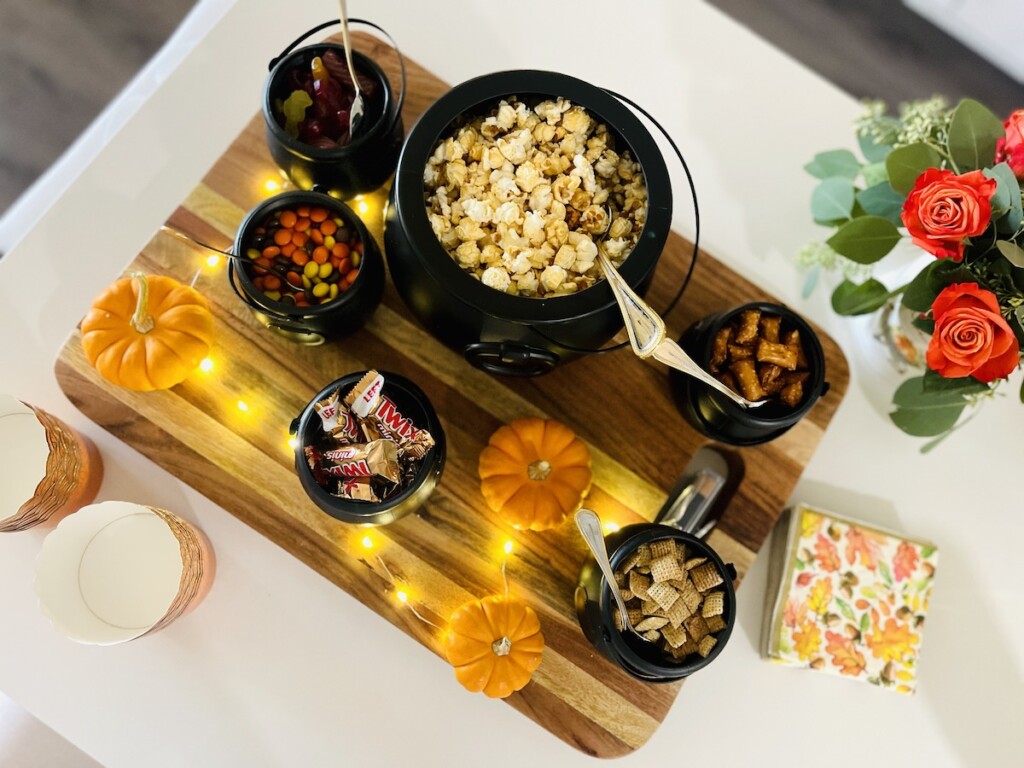 halloween popcorn bar displayed on a big wood board