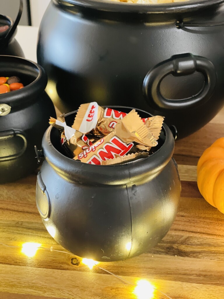 mini twix bars in a mini plastic cauldron