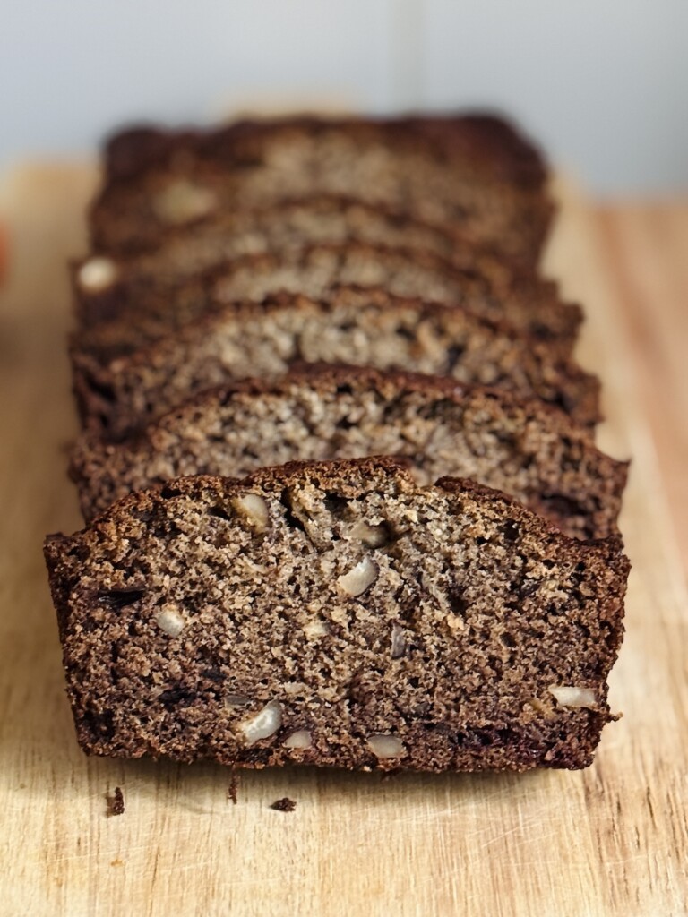 persimmon bread slices stacked in a loaf pattern